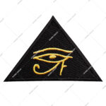 Embroidered Triangular Patch Featuring The Egyptian Eye Of Horus Symbol In Gold Stitching On A Black Background